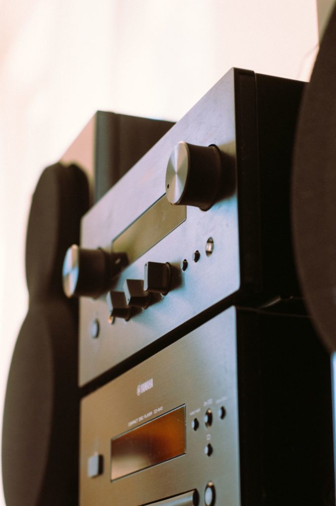 A compact hi-fi system with amplifier and CD player between loudspeakers A compact hi-fi system with amplifier and CD player between loudspeakers