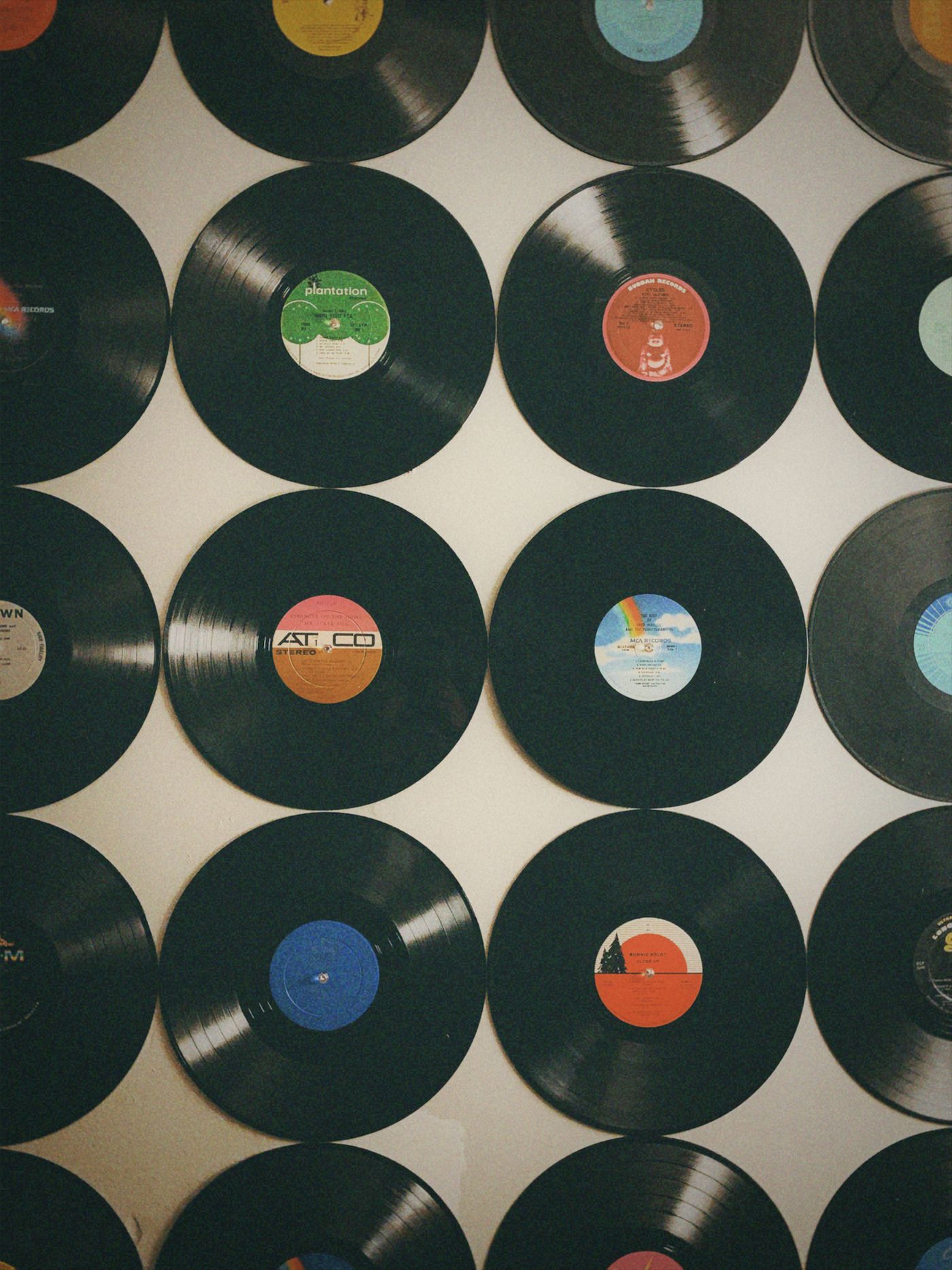 A wall covered in vinyl records