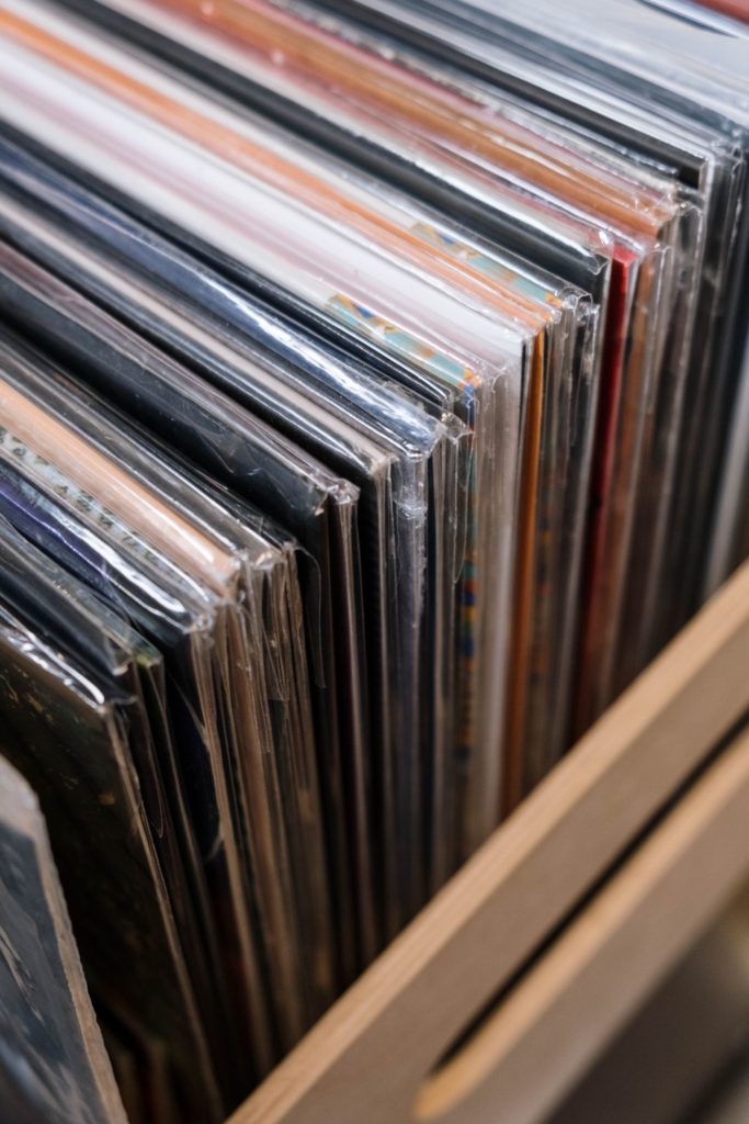 Vinyl records in protective sleeves standing in a crate